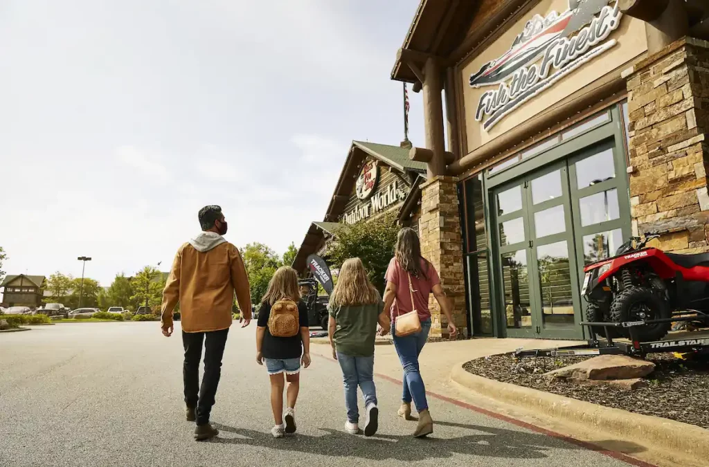 Family of four walking together toward Bass Pro Shops in Springfield, MO