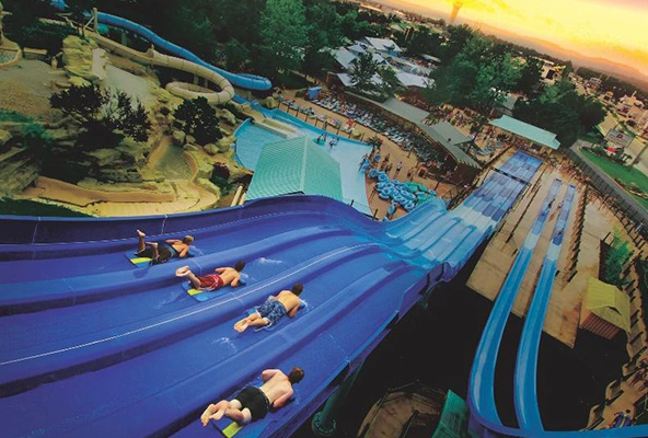 Children sliding down a large blue water slide at White Water park in Branson, MO