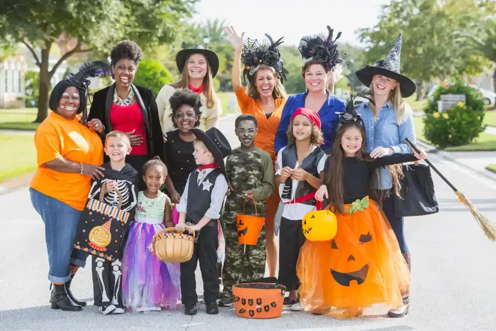 Group of women with children in halloween costumes