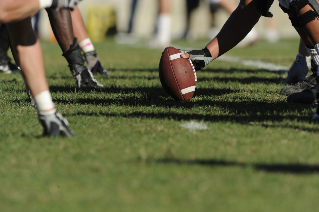 Players on the football field during a game in the Springfield sports scene