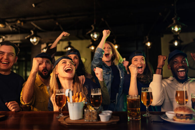Fans cheering with drinks at the local Springfield sports scene